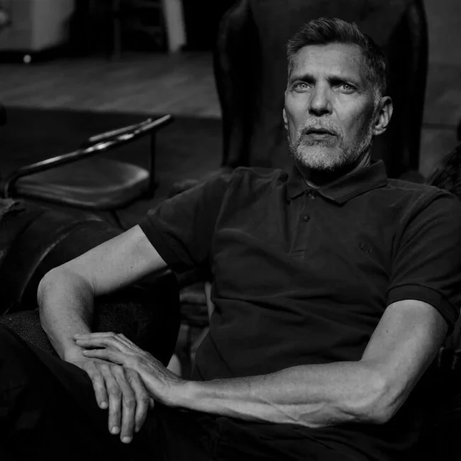 Portrait of the Dutch photographer Erwin Olaf in high-contrast black and white.